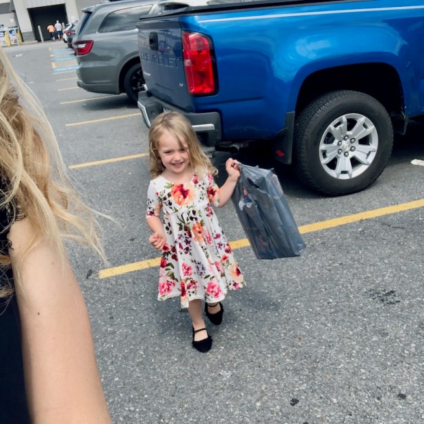 Girl walking out of store with shopping bag