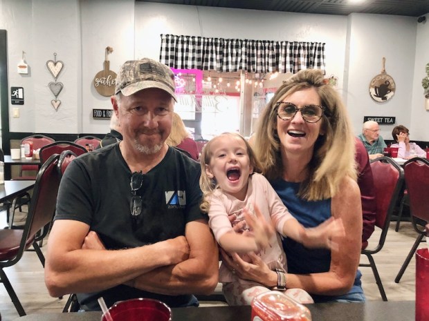 Granddaughter with grandparents in a diner
