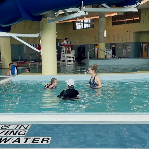 Mom and daughter in pool for swim lesson