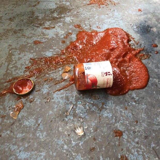 Broken glass jar of pasta sauce