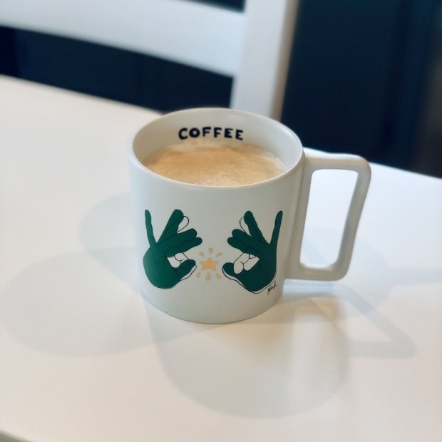 Nespresso coffee in Starbucks sign language mug
