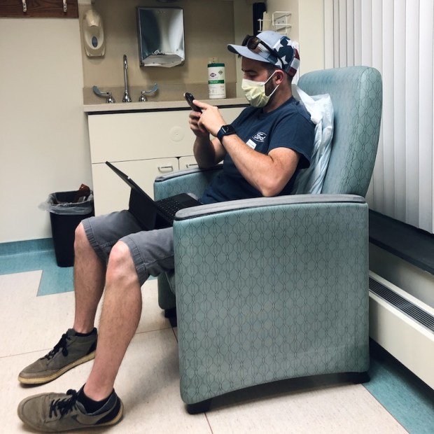 Guy sitting in infusion room at UPMC Hillman Cancer Center in Pittsburgh, PA
