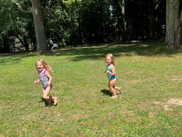 Two cousins playing outside in the summer