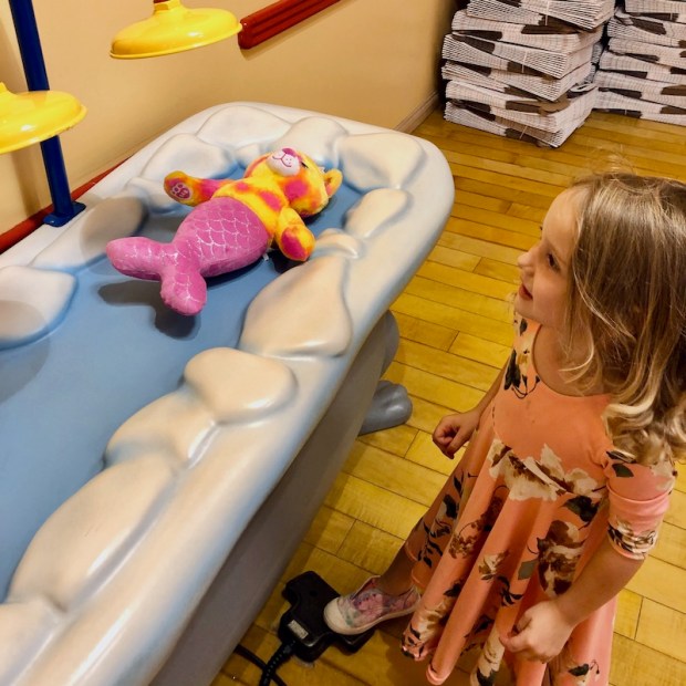Girl giving air bath at Build-A-Bear