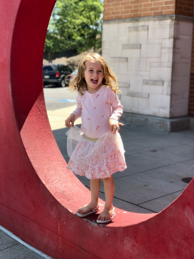Young girl standing outside of Target in archway