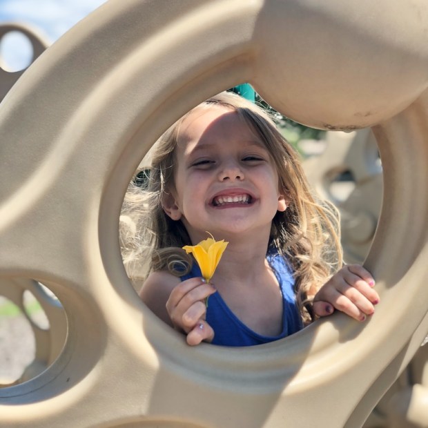 Young girl holding a tiger lily
