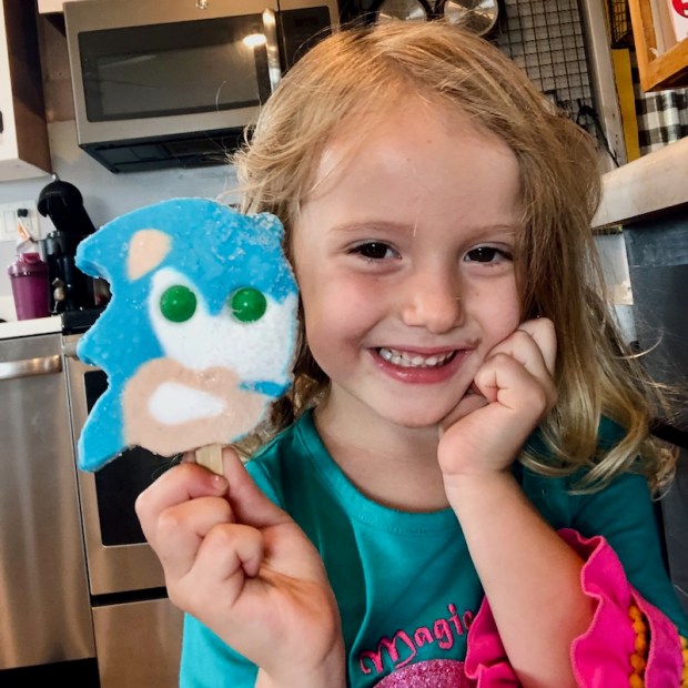 Young girl with Sonic the Hedgehog ice cream from ice cream truck