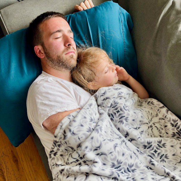 Dad and daughter napping on couch