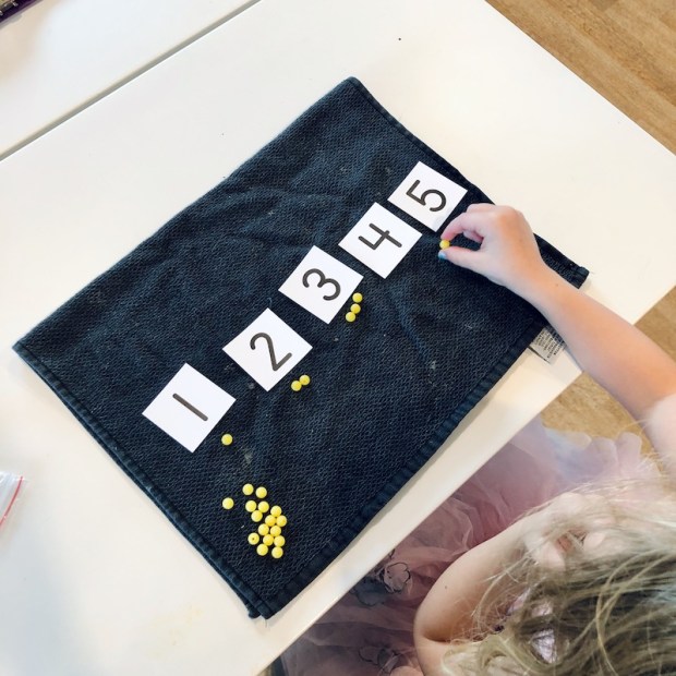 Girl doing math with Sonlight curriculum 