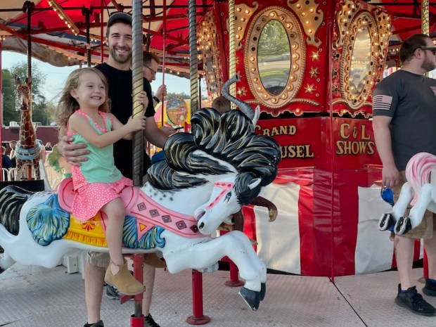 Girl riding merry go round at Washington County Fair