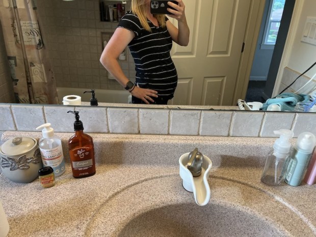 Girl's baby bump with black and white striped maternity shirt