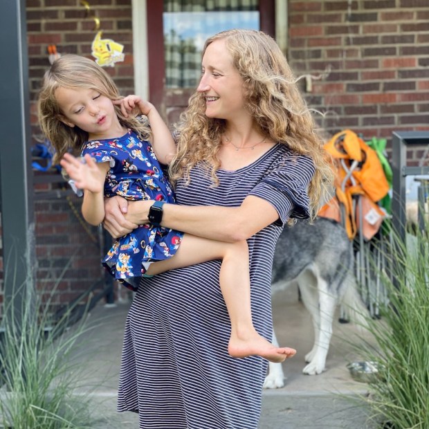 Mom holding daughter wearing a Sonic the Hedgehog dress