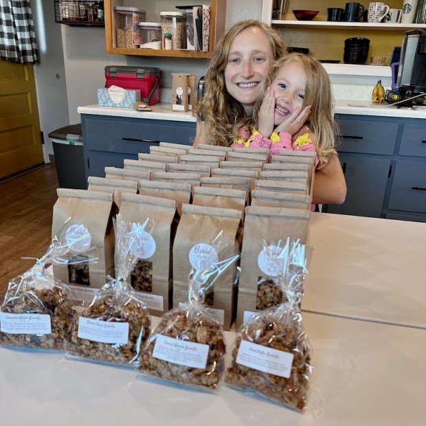 Mom and daughter with 14 pounds of granola for wholesale bakery order