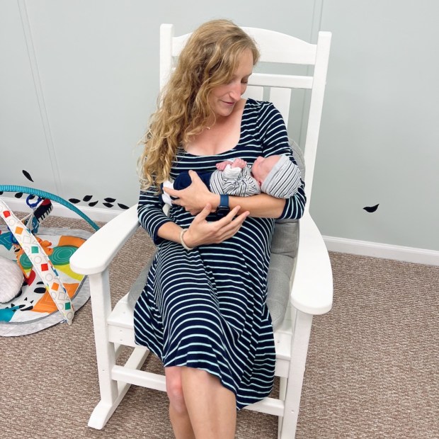 Girl holding four pound baby in nursery