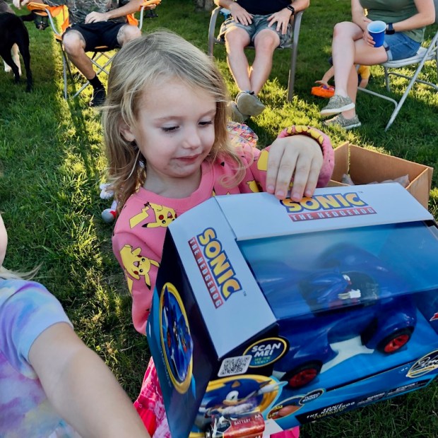 Girl holding Sonic the Hedgehog remote controlled car