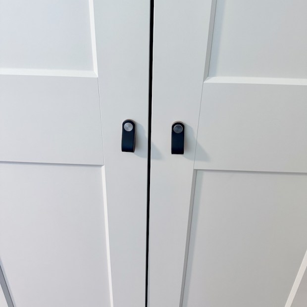 Black leather door pulls on white Ikea wardrobe