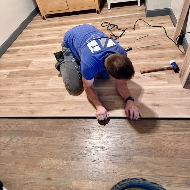 Guy installing flooring in nursery