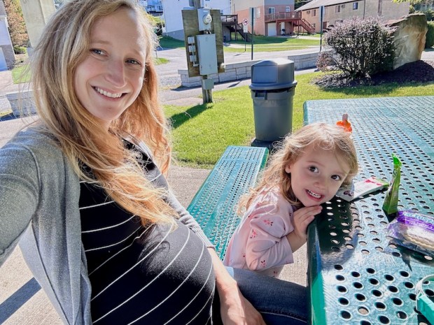 Mom and daughter selfie at picnic table in park