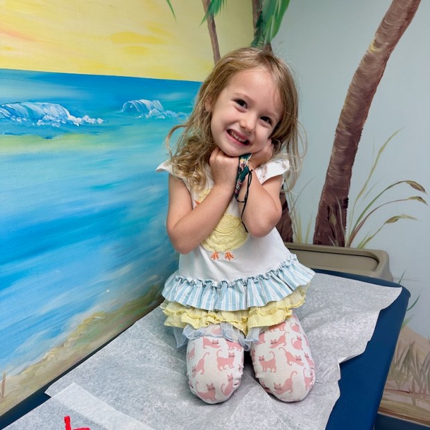 Four year old sitting on doctor table for checkup