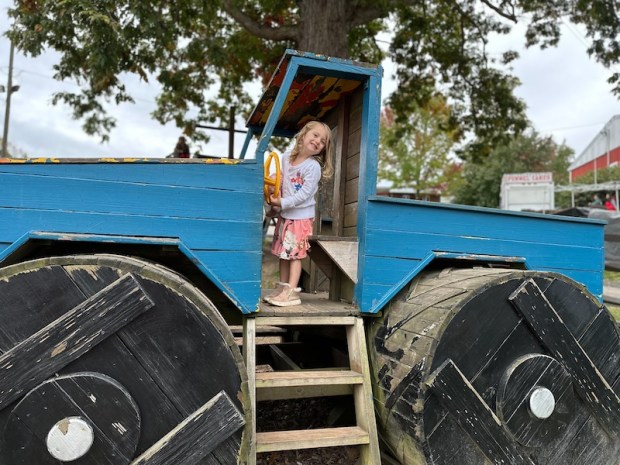 Girl in wooden monster truck