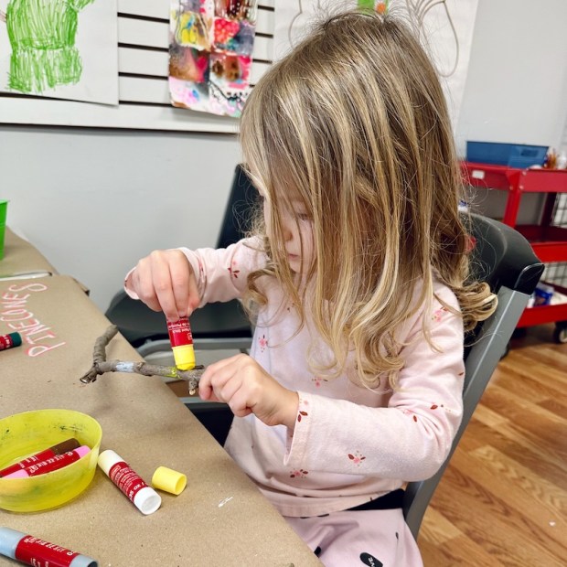 Girl painting a stick in art class at Artsmiths of Pittsburgh in Carnegie, PA