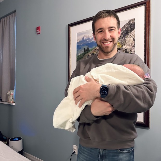 Dad holding newborn son