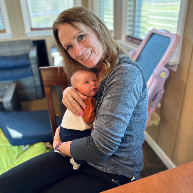 Grandma holding newborn baby boy