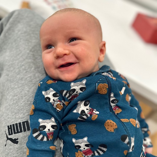 Five week old baby boy smiling