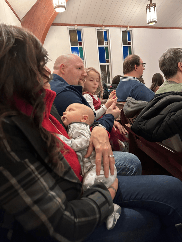 Grandparents holding grandkids at church