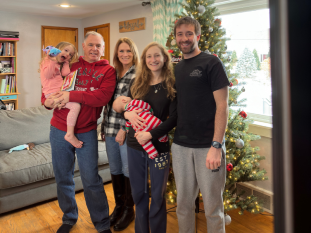 Family in front of Christmas tree