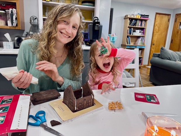 Mom and daughter making gingerbread houses