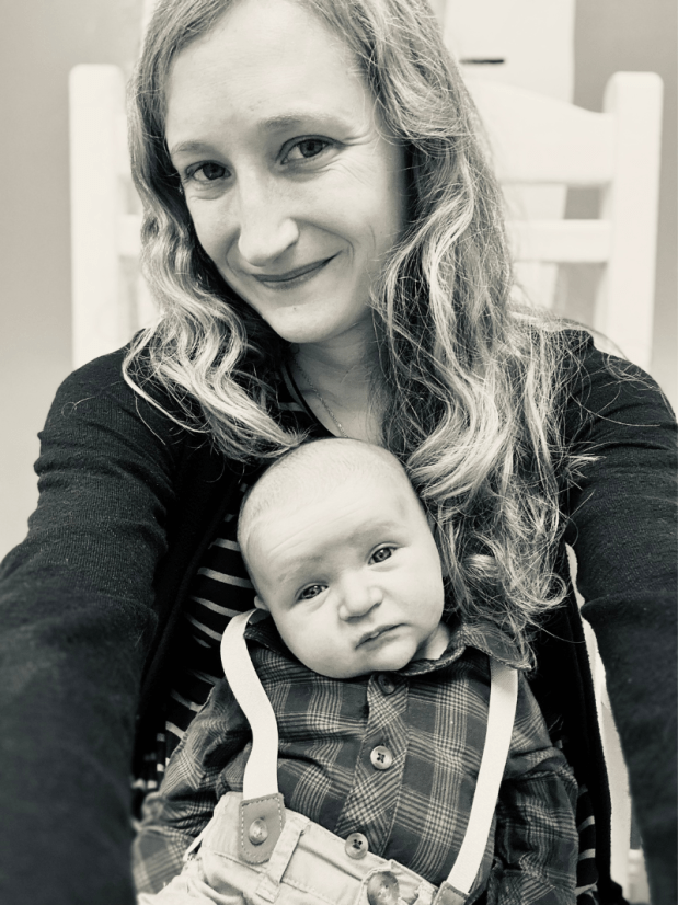 Mom with newborn baby sitting on her lap