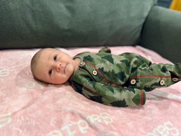 Baby boy wearing Christmas tree footie pajamas 