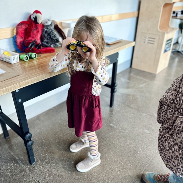 Girl with binoculars at the National Aviary in Pittsburgh, PA