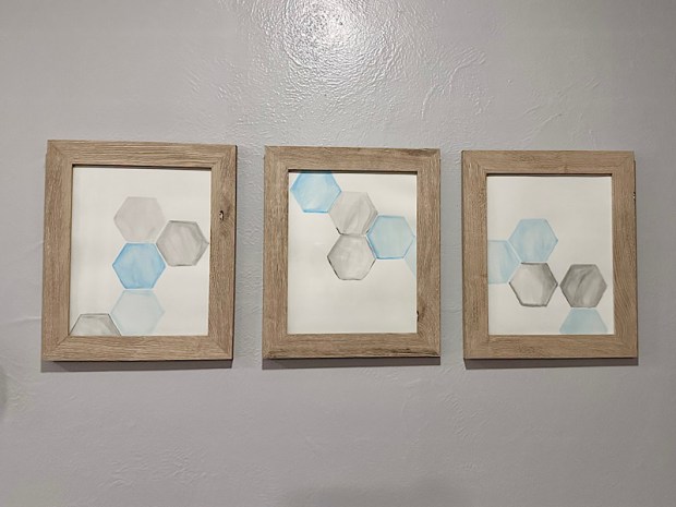 Geometric blue and gray watercolor art in weathered frames