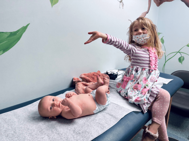 Girl and baby boy at doctor's office