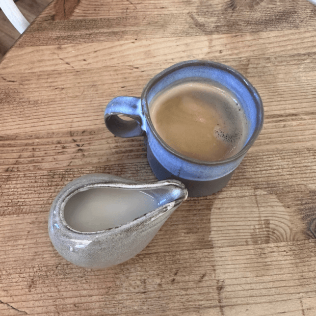 Coffee and cream on wooden table
