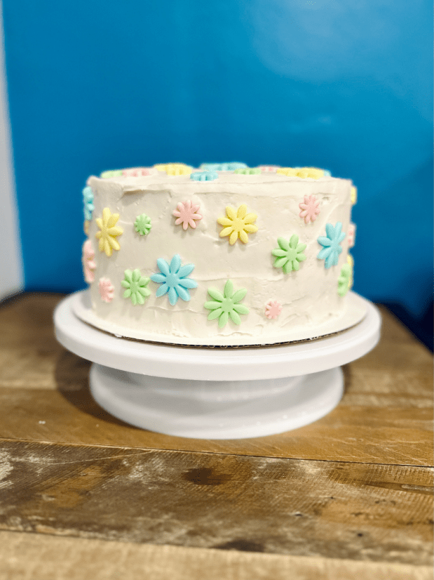 Boho daisy birthday cake with pastel fondant flowers
