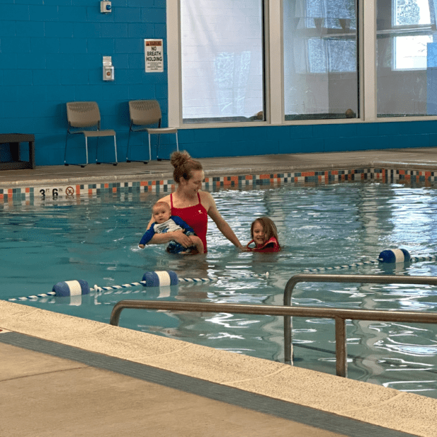 Mom in pool with baby and preschooler