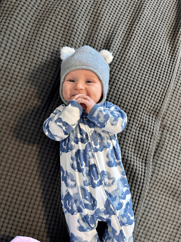 Baby boy wearing gray hat with Pom Pom ears