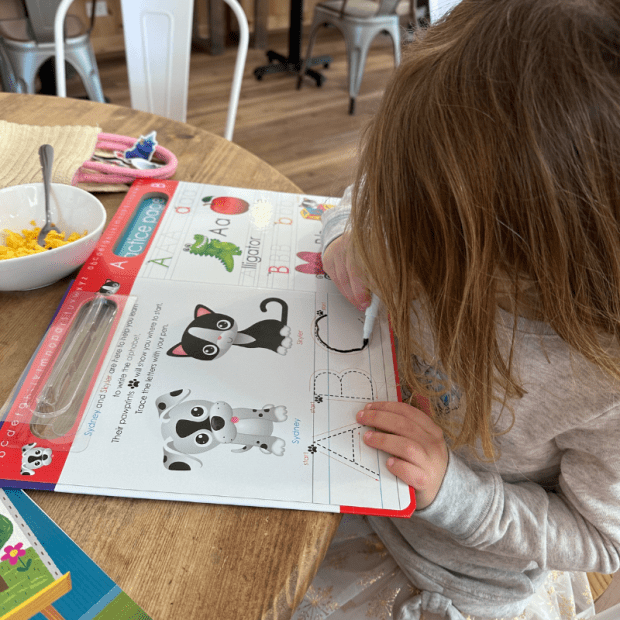 Girl writing in write and wipe book