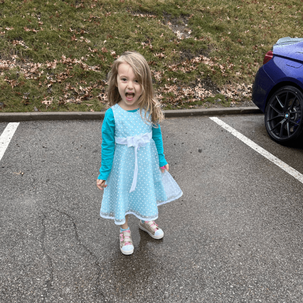 Four year old girl wearing blue dress