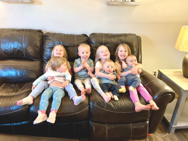 Group of young grandkids sitting on couch together
