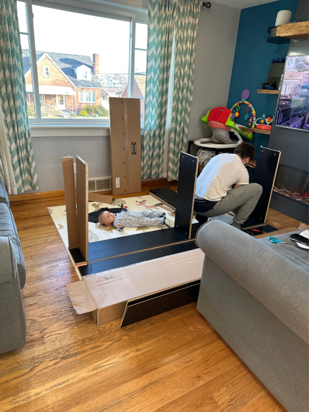 Guy putting together IKEA Billy bookshelf