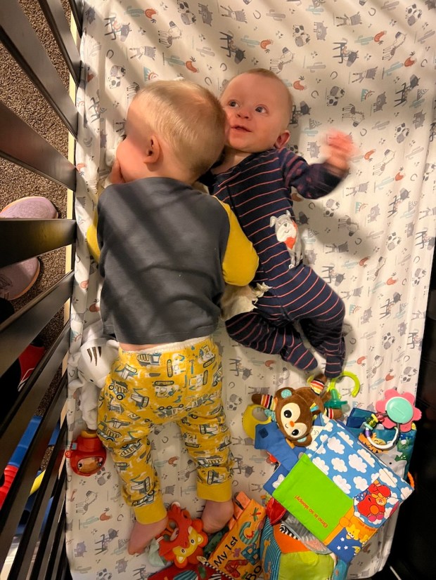 Boys laying in crib