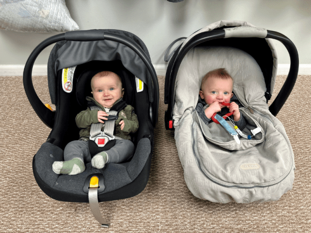 Baby boys side by side in carseats