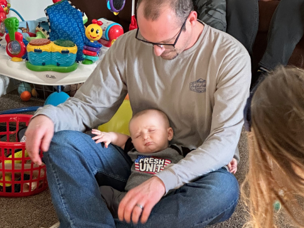 Baby sleeping on guy's lap