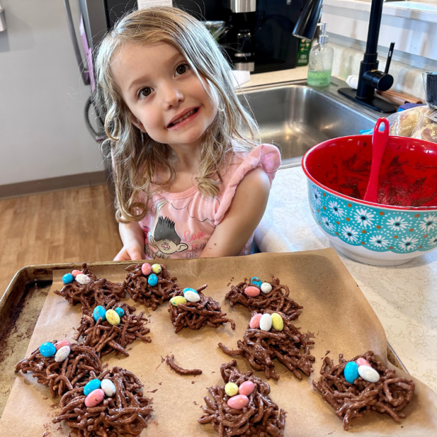 Young girl with bird's nest cookies for spring