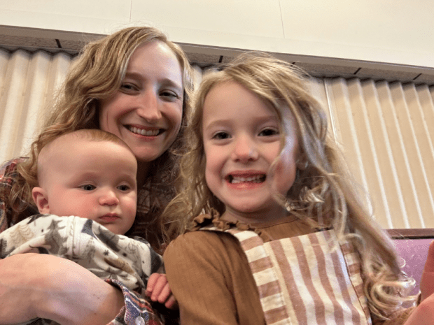 Mom sitting in church with kids