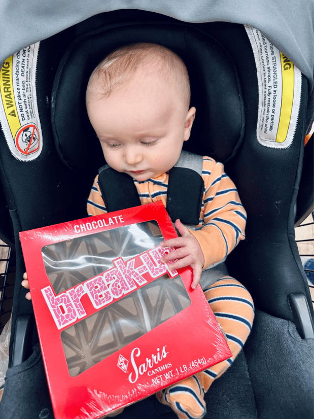 Baby boy holding Sarris chocolate